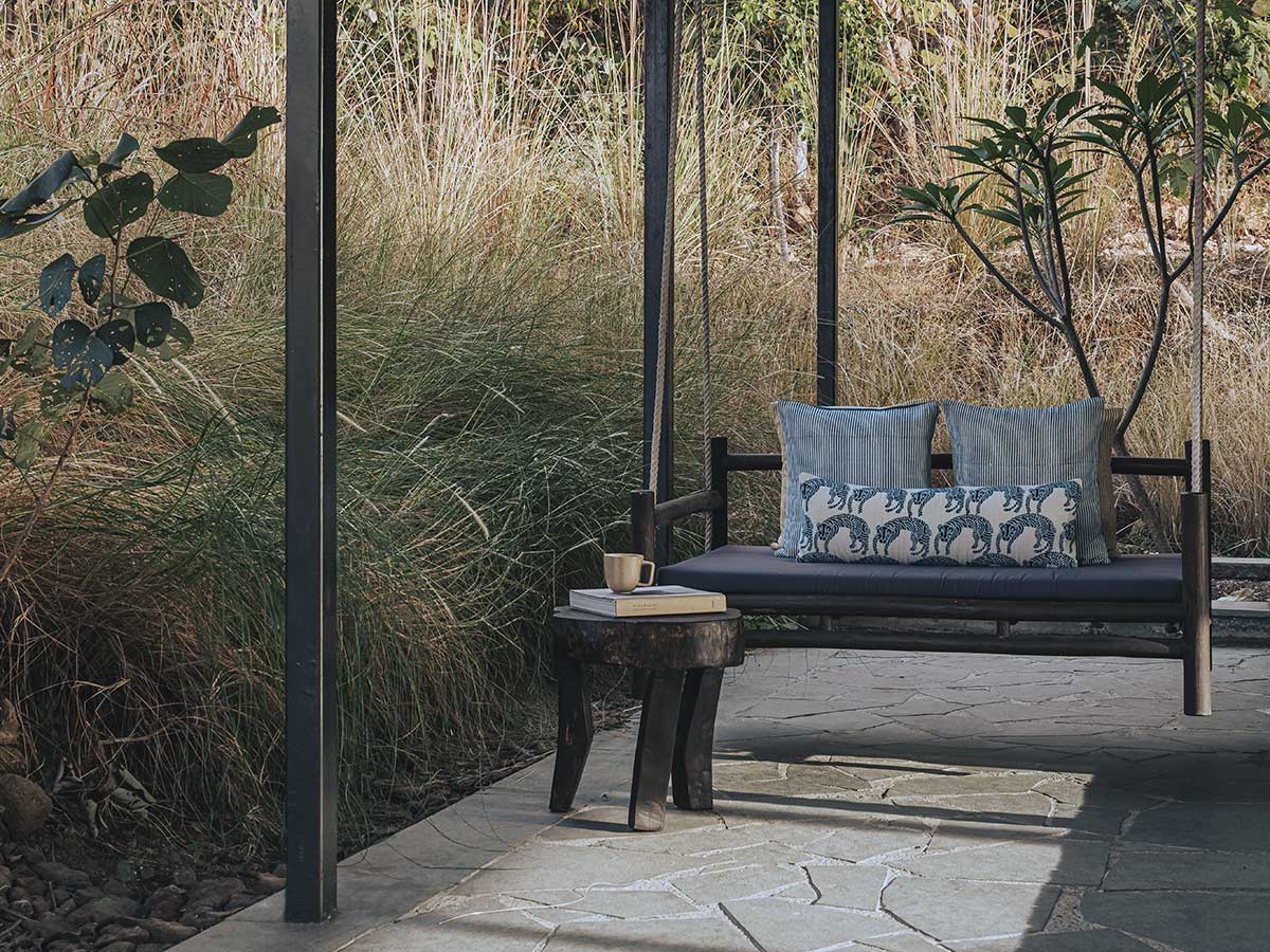 Warmly lit villa interior at golden hour – intimate jungle stay Tipai Maharashtra