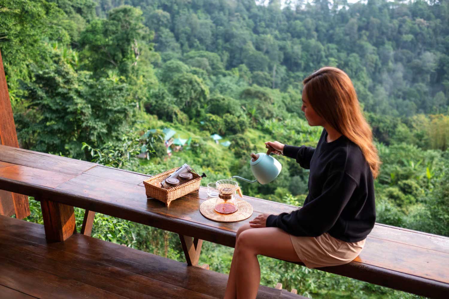 A guest reading a book on a private villa sit-out at Tipai during unscheduled midday time